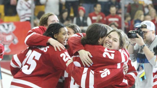Wisconsin's Casey O'Brien (26) and Maddi Wheeler (28) embrace after the Badgers defeated Ohio State, 1-0, in the NCAA Division I women's hockey national final Sunday March 19, 2023 at AMSOIL Arena in Duluth, Minn. Uwice Ohio State 4 March 19 2023